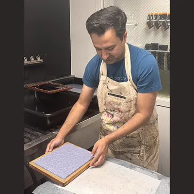 Da Vinci Professor Jaswinder Bolina works in a papermaking studio while developing a hands-on bookmaking project that is expected to become a Da Vinci course in 2027.
